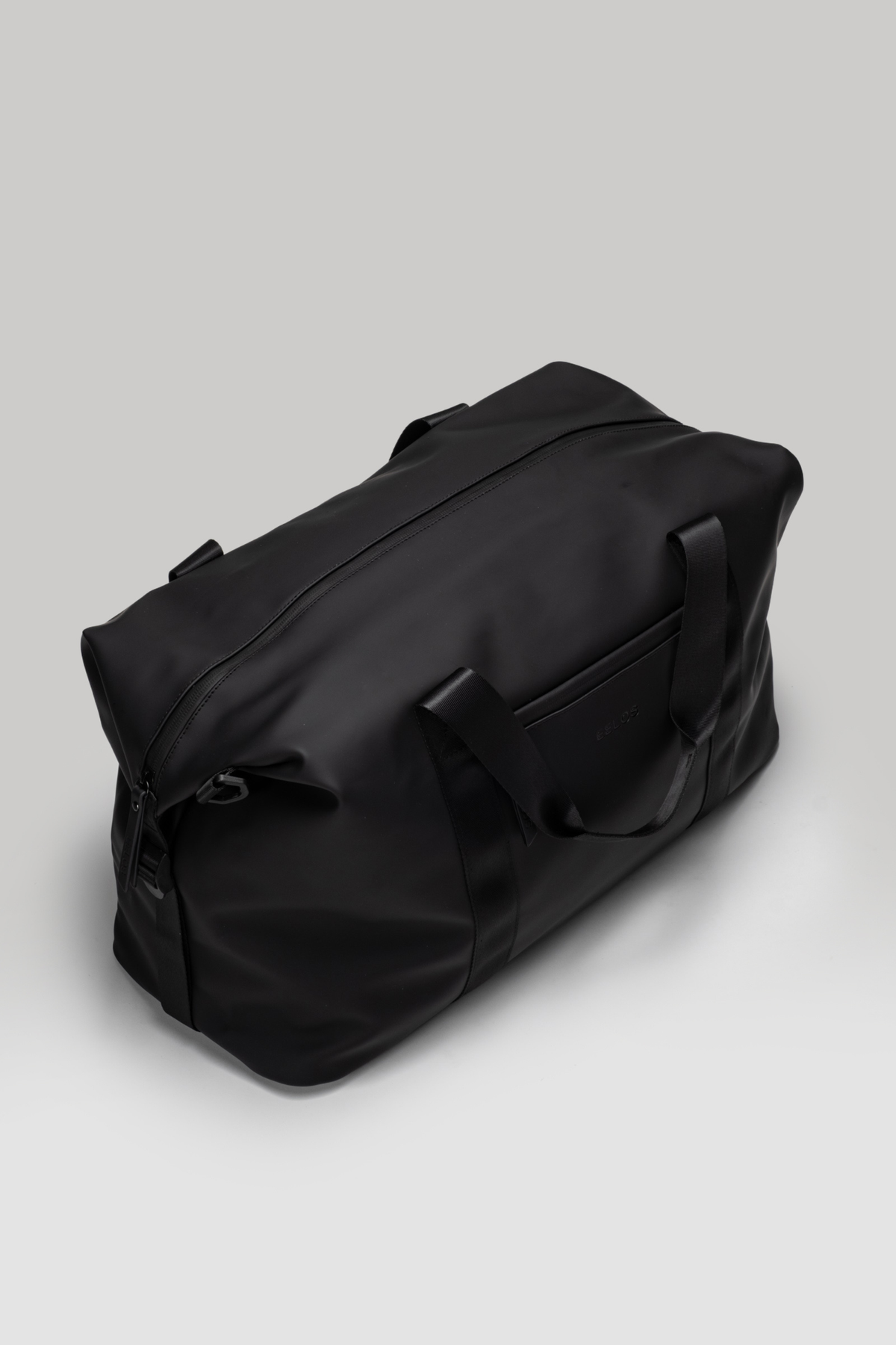 Black duffel bag on a light gray background