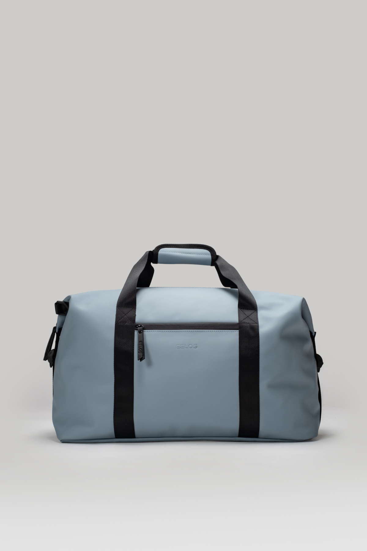 Light blue duffel bag with black straps on a light gray background