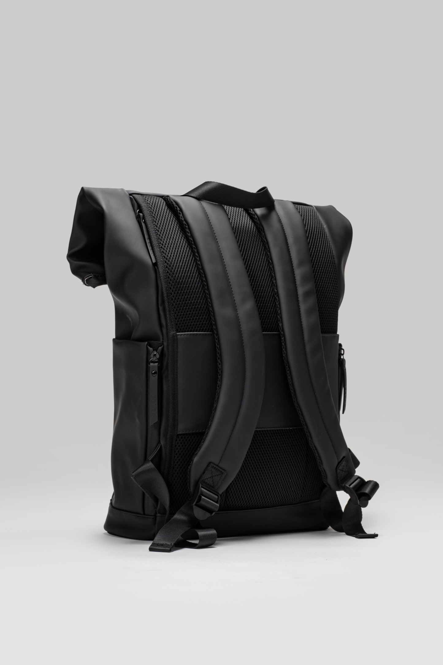 Black backpack on a light gray background