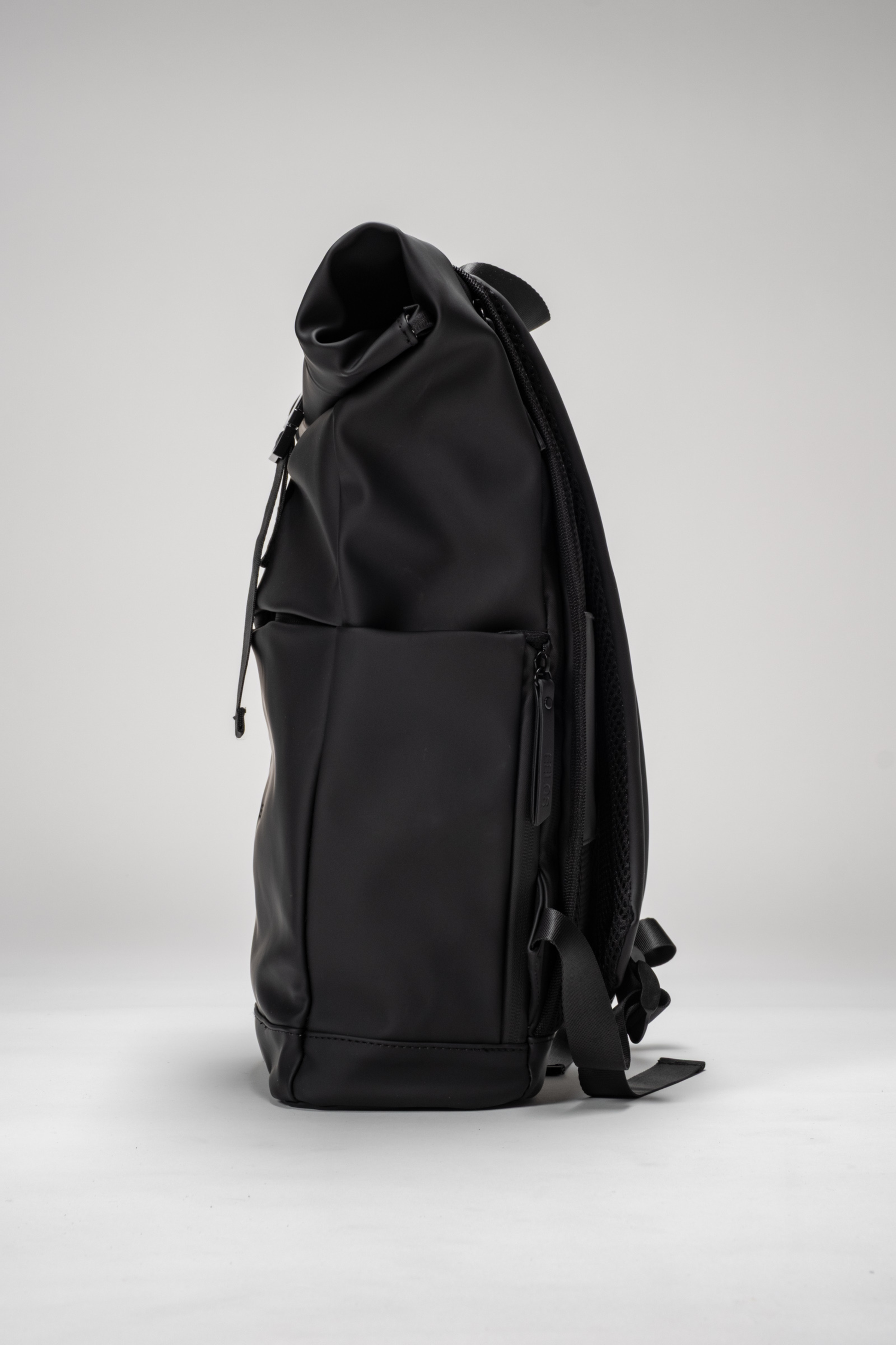 Black backpack on a light gray background