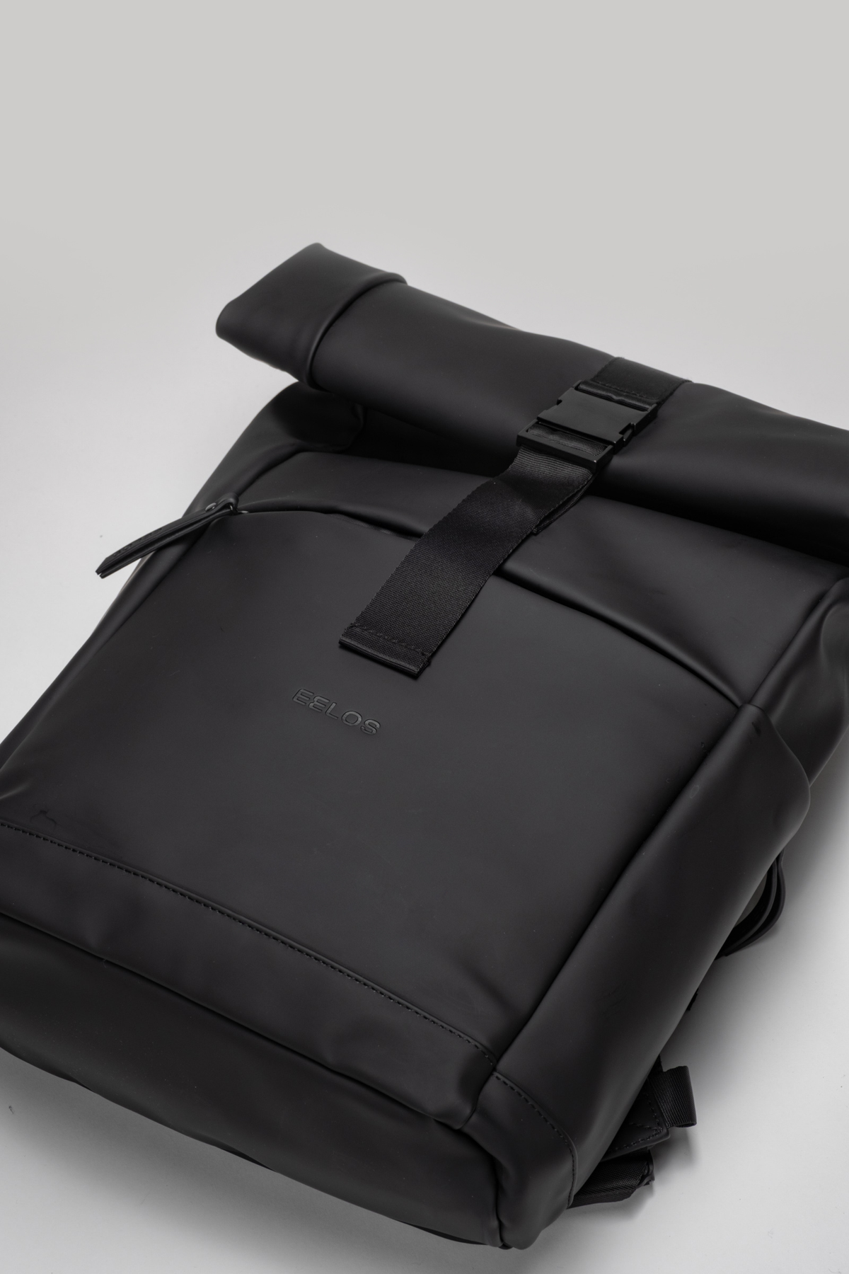 Black backpack on a light gray background