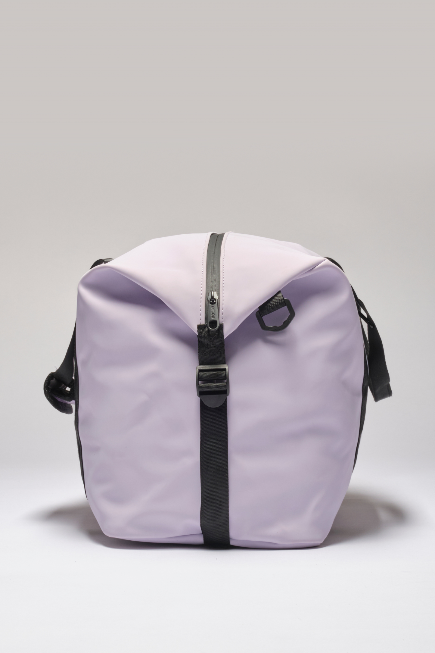 A light purple waterproof duffel bag with black straps and a black zipper, photographed against a neutral light gray background.