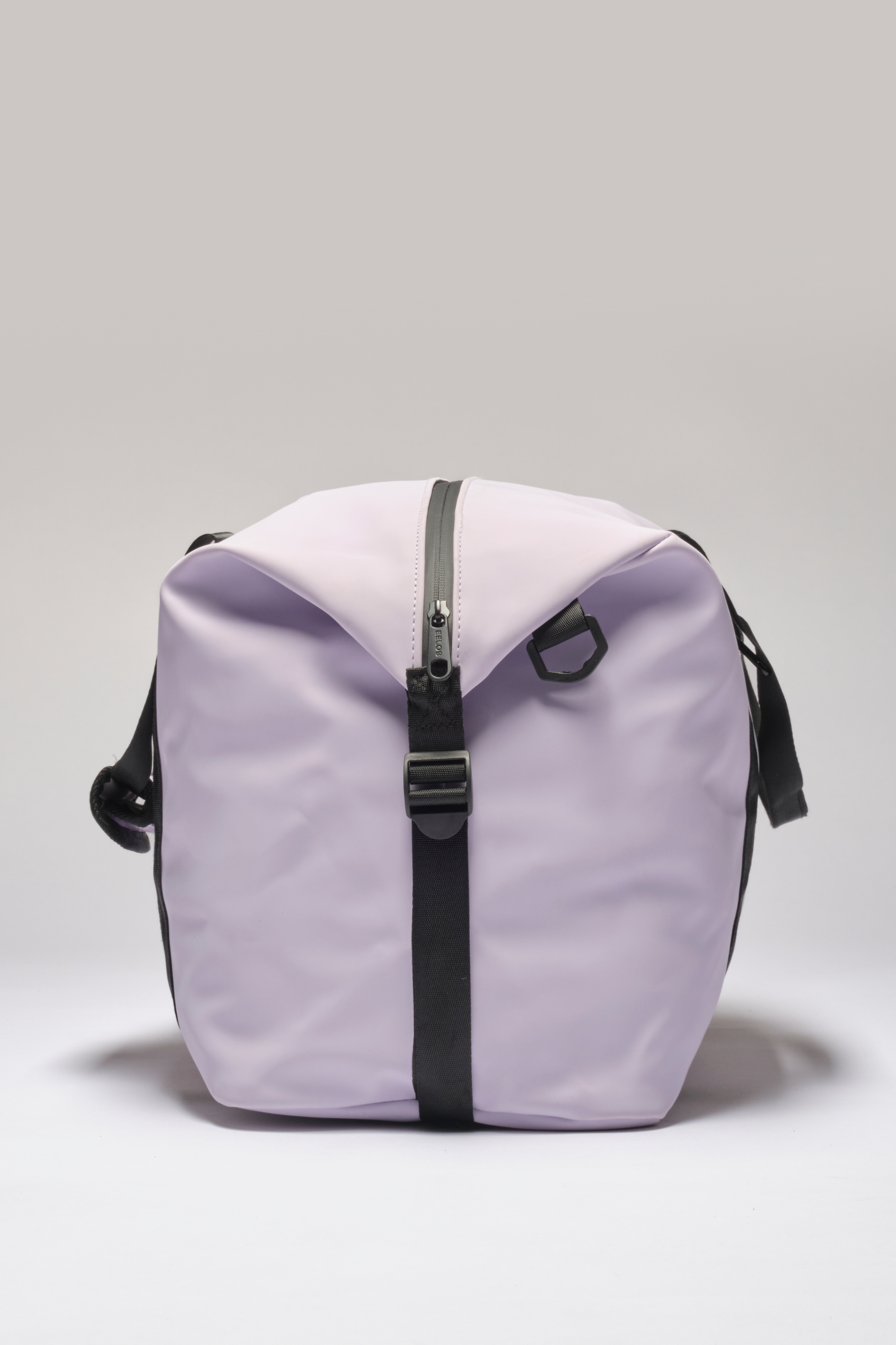 A light purple waterproof duffel bag with black straps and a black zipper, photographed against a neutral light gray background.