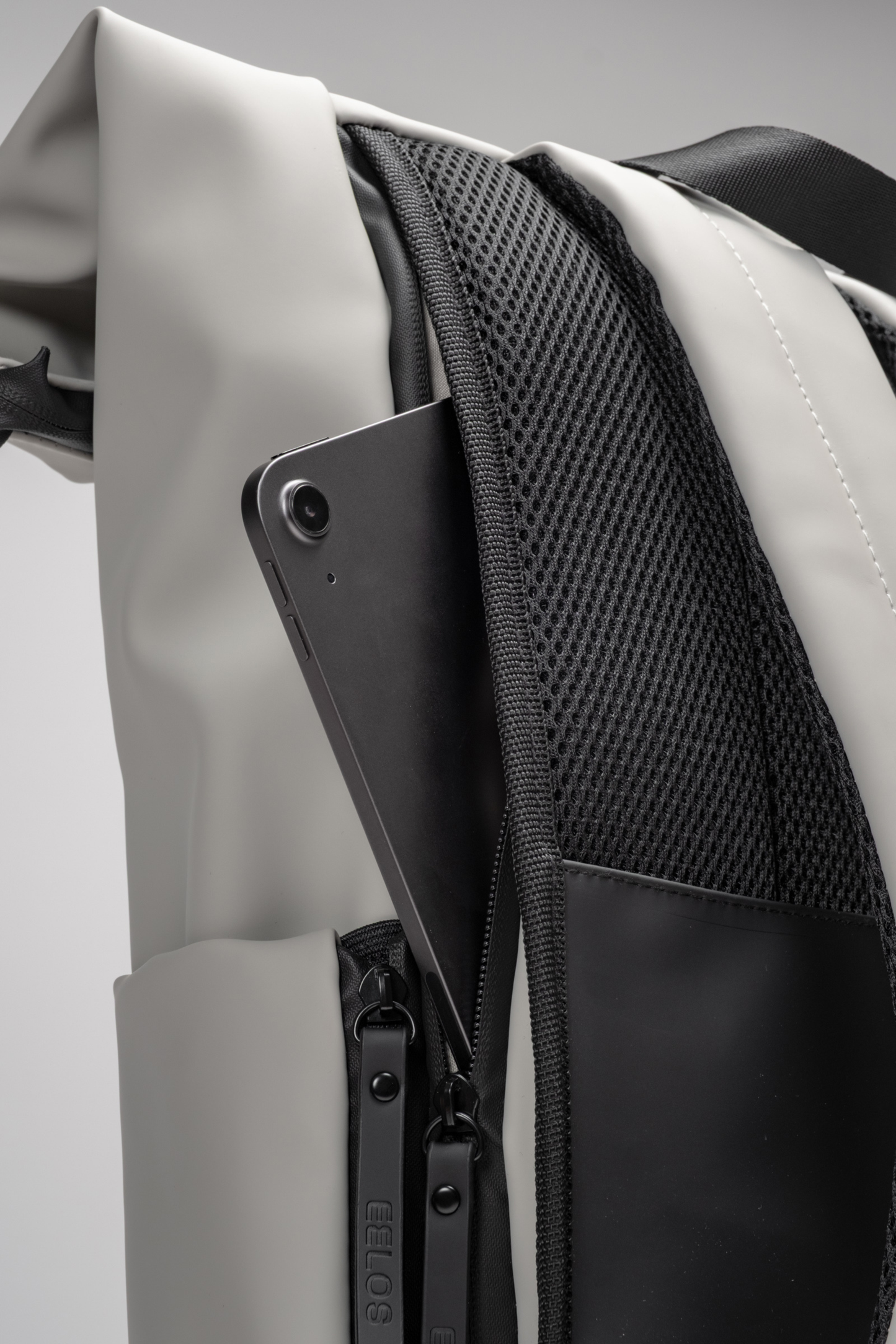Close-up of a backpack with a gray and black design on a light gray background